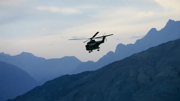 Military Helicopter in flight in Hunza region of Karokoram Mountains, Pakistan